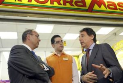 Fotografía facilitada por la Comunidad de Madrid del presidente regional, Ignacio González (d), que conversa con el consejero delegado de la cadena de supermercados AhorraMas, Eusebio Rubio Martín (i), junto a Jesús Naváref Sánchez (c), empleado 10.000 de un supermercado AhorraMas en el barrio madrileño de Valdebernardo.