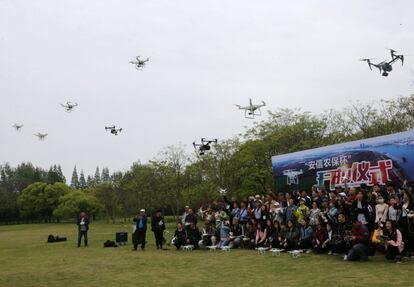 Varias personas vuelan drones durante la ceremonia de presentación de un concurso de fotografía aérea en Shanghai (China).
