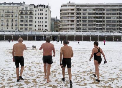 Not even snow can stop these bathers from having their daily swim in San Sebastián.