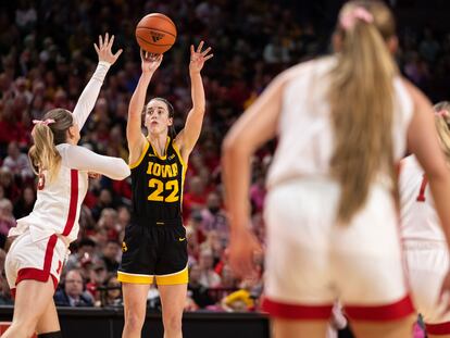 Iowa's Caitlin Clark, second from left, shoots against Nebraska's Kendall Moriarty, left, during the second half of an NCAA college basketball game Sunday, Feb. 11, 2024, in Lincoln, Neb.