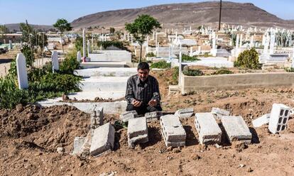 Omar Bashah reza ante la tumba de su padre, fallecido en el campo de desplazados de Heryelah a los dos días de escapar de Guta Oriental.