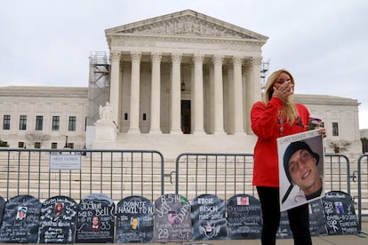 A woman reacts as campaigners and family members of those who have died of opioids gather outside the US Supreme Court, Washington, DC, USA