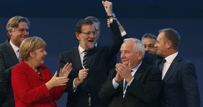 El presidente del Consejo Europeo, Donald Tusk (d), levanta el brazo del presidente del Gobierno, Mariano Rajoy (c), junto al presidente el PPE, Joseph Daul (2d), y la canciller alemana, Angela Merkel (i), mientras posan para la foto de familia del Congreso del Partido Popular Europeo (PPE) que se clausura hoy en Madrid. 