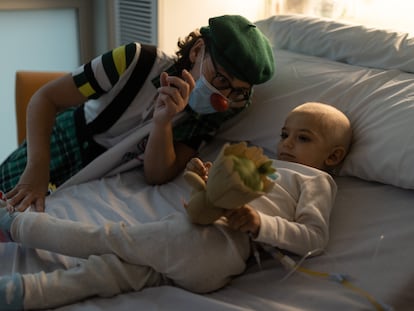 Ante un diagnóstico de cáncer infantil las familias solo necesitan un asidero firme para continuar. En la imagen, Luis Escuder (de dos años) durante una visita de una payasa de la ONG Pallapupas.