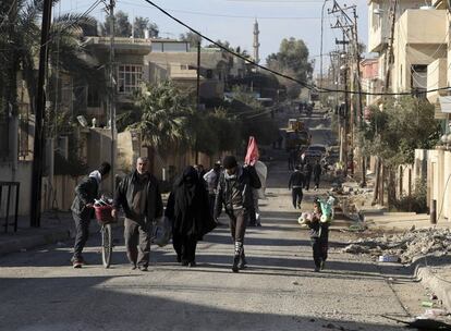 Un alto mando del Ejército iraquí anunció el pasado 18 de enero la liberación total del este de Mosul. El Ejército llevaba desde el 13 de enero esperando las condiciones pertinentes en la batalla para cruzar el estratégico río Tigris. Cinco días después, Talib al-Sheghati, un general de las Fuerzas Antiterroristas, que ha sido la punta de lanza de la operación, anunciaba "la liberación... del margen izquierdo". A partir de entonces, los esfuerzos se iban a centrar en intentar retomar el control de la Ciudad Vieja. En la imagen, un grupo de civiles sale a por comida en esa zona de la urbe, el 17 de enero.