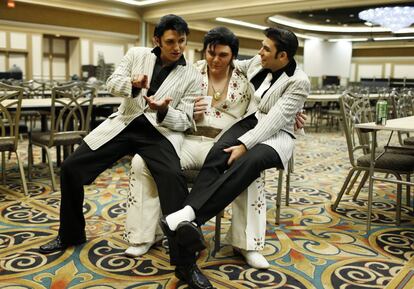 In this July 12, 2014 photo, from left, Daniel Jenkins, Tyler James and Jacob Roman joke around during the Las Vegas Elvis Festival in Las Vegas. The three, along with other Elvis tribute artists, performed in a competition at the convention. (AP Photo/John Locher)