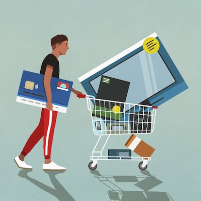 Male consumer with credit card pushing shopping cart with technology merchandise