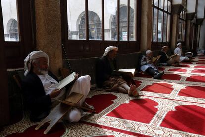 Varios yemeníes leen el Corán durante el mes de ayuno del Ramadán en una mezquita en Saná (Yemen).