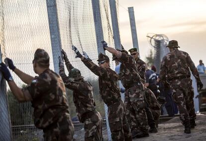 Varios soldados del ejrcito hngaro colocan una barrera tras cerrar la frontera con Serbia en R?szke, a 180 kilmetros de Budapest, Hungra.