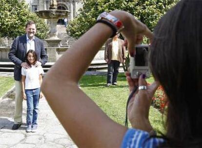 Rajoy se deja fotografíar con una admiradora en la plaza de la Herrería de Pontevedra.