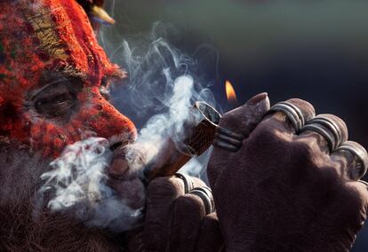 Un 'sadhu' u hombre santo fuma una pipa de marihuana este lunes en el templo Pashupati de Katmandú (Nepal), durante las celebraciones de la festividad hindú Maha Shivaratri.