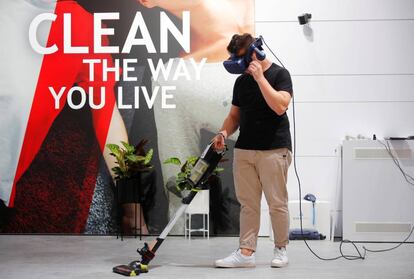 A man with VR glasses tests a Hoover vacuum cleaner at the IFA consumer electronics fair in Berlin, Germany, September 4, 2019. REUTERS/Hannibal Hanschke