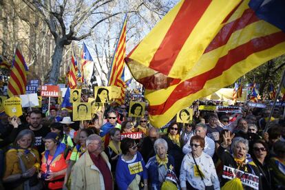 Protesters wave images of the 12 Catalan independence leaders on trial for organizing an illegal referendum.
