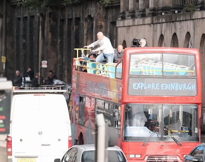 A stuntman prepares to jump from a bus during filming in Edinburgh, Scotland.