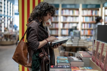 Una lectora hojea un libro este domingo en una céntrica librería de Barcelona, el fin de semana previo a la diada de Sant Jordi.
