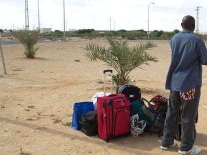 Um imigrante africano espera um meio de transporte depois de ser libertado no Neguev, no sul de Israel.
