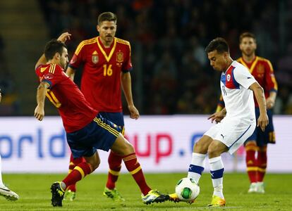 Cesc disputa el balón con Vargas.