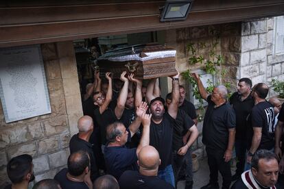 Mourners carry the coffins of two of the five Palestinian citizens of Israel, killed a day earlier when a gunman opened fire at a car wash in Yafa an-Naseriyye, Israel, during their funeral, on June 8, 2023