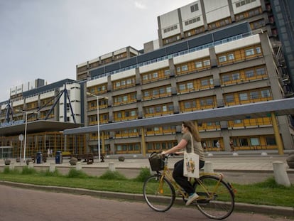 Una mujer va en bicicleta por un campus holandés. 