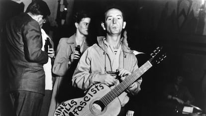 American folk musician Woody Guthrie with an anti-fascist message on his guitar
