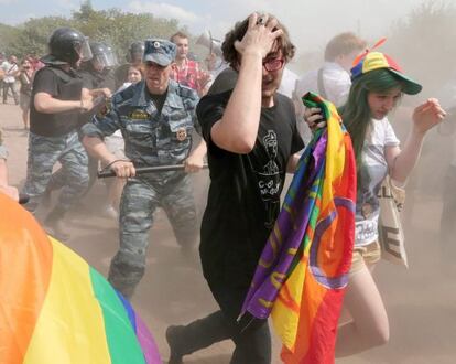 Dos activistas huyen en la marcha del Orgullo Gay en San Petersburgo tras la intervenci&oacute;n de la polic&iacute;a.