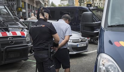 Officers from the Catalan and National Police force during a raid.