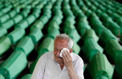 Un hombre llora en el lugar donde se guardan los cadáveres de las víctimas antes de recibir sepultura en el cementerio de Potocari, Srebrenica.