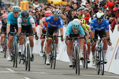Gaviria, a la izquierda, sonríe viendo a Cavendish lanzar la bicicleta para ganar en Zipaquirá.