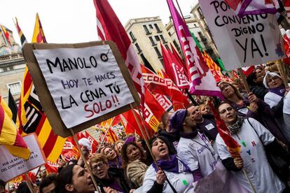 Women in Barcelona hold up a sign that reads