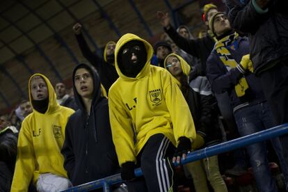 In this Tuesday, Jan. 29, 2013 photo Beitar Jerusalem F.C. soccer supporters watch a State Cup soccer match against Maccabi Umm al-Fahm F.C. at the Teddy Stadium in Jerusalem. Beitar has long tried to quell a tight-knit group that calls itself "La Familia" and whose behavior has had the team docked points and forced it to play before empty stadiums. The group is routinely abusive toward opposing players, taunting them with racist and anti-Arab chants. (AP Photo/Bernat Armangue) The offices of the Beitar Jerusalem soccer team were set on fire early Friday in an apparent arson attack, police said, a day after four of the club's fans were charged with anti-Muslim chanting at a recent game. Tensions have been bubbling ever since the team announced last month it would sign on two Muslim Chechen players x97 Zaur Sadayev and Gabriel Kadiev x97 in a break from the team's unofficial tradition of not signing Arabs or Muslims. (AP Photo/Bernat Armangue)