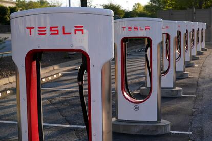 FILE - In this April 22, 2021, photo shows a Tesla Supercharger station in Buford, Ga. Tesla reports earnings on Wednesday, Jan. 25, 2023.