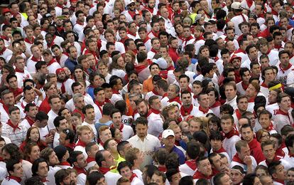 Cientos de corredores atienden a las normas del encierro que se proyectan en la pantalla colocada este año en la Plaza Consistorial antes de correr el segundo encierro de los Sanfermines 2014.