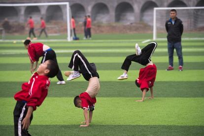 Según el Partido Comunista de China, el país se va a convertir en una superpotencia del fútbol en el año 2050. En la imágen, estudiantes calientan antes de jugar al fútbol, en la escuela de artes marciales de Tagou, en Dengfeng (China).