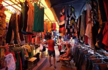 Compradores observan algunas prendas en una tienda de ropa importada ofertada por comerciantes privados este 11 de octubre de 2013, en La Habana (Cuba).