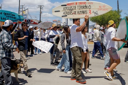 Surfers march in Ensenada in Baja California, on Sunday.