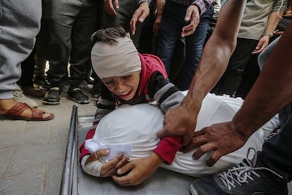 A child cries over the body of a relative after the Israeli attack on the Fahmi al-Jarjaw school in Gaza City on Monday.