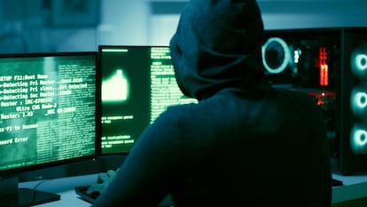 Back of hacker, person and dark computer for cybersecurity, ransomware and data password for crime. Error, thief and spy coding pc software for scam, phishing and hacking online firewall with malware