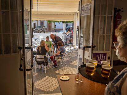 A waitress serving drinks in Almensilla, Seville last month.