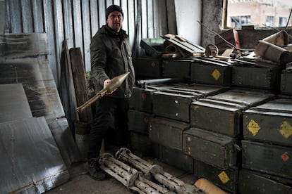 Sergei Yatsenko displays ammunition left by the Russians after their month-long occupation of the farm.