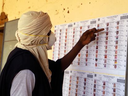 Un votante con mascarilla busca su nombre en el censo de un colegio electoral de Gao, en Malí, durante las elecciones legislativas celebradas este domingo.