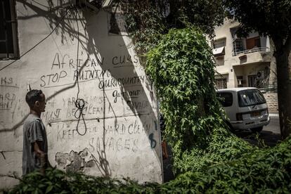 Un hombre pasa junto a una pared con una pintada racista escrita en inglés en la zona sur de Tel Aviv: “Malditos africanos. Basta ya de echar a perder nuestro país. ¡Fuera! Salvajes. ¡Dejad de ensuciar el patio! Salvajes”. En Israel, los solicitantes de asilo sufren una discriminación social generalizada y las instituciones del Estado no los reconocen como demandantes legítimos.