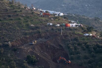 A digger removes earth during the rescue operation, which involves drilling two tunnels.