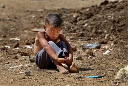 FILE - In this Wednesday, Sept. 11, 2013 file photo, A Syrian refugee boy sits on the ground at a temporary refugee camp, in the eastern Lebanese Town of Al-Faour, Bekaa valley near the border with Syria, Lebanon. UNICEF on Monday, March 14, 2016 said it verified close to 1,500 grave violations against children in 2015, including killings and abductions. The agency says the actual figure is believed to be higher. (AP Photo/Hussein Malla, File)