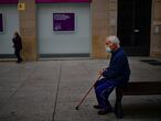 An elderly man sits on a bench wearing a face mask to protect against coronavirus, in Pamplona, northern Spain, Saturday, Oct. 17, 2020. (AP Photo/Alvaro Barrientos)
