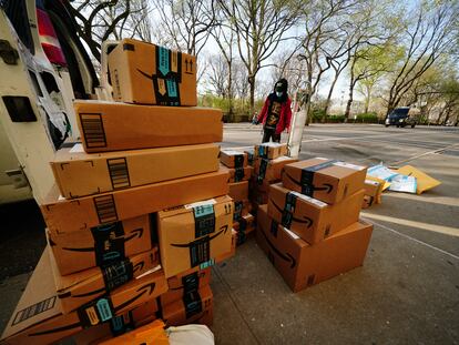 Un hombre mira paquetes entregados por Amazon durante la cuarentena.