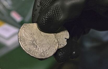 A Culture Ministry official shows some of the coins from the Mercedes trove.