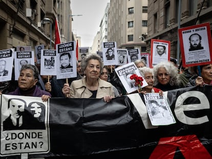 Relatives of disappeared detainees walk to the General Cemetery on the 50th anniversary of the coup d'état in Chile.