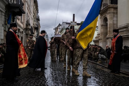 Soldier carry the coffin of soldier Yurii Bulharu during a funeral ceremony outside the Holy Apostles Peter and Paul Church in Lviv, western Ukraine, on Saturday, Feb. 25, 2023.