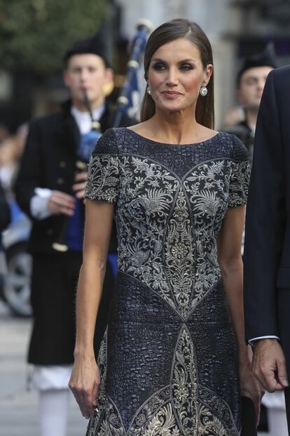 La reina ha optado por un peinado hacia atrás, con el pelo en un efecto húmedo, para lucir mejor el escote barco del vestido y los grandes pendientes de diamantes.