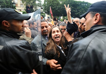 Maya Jeridi, líder del partido progresista de la oposición, rodeada de policías en la protesta que se produjo en las calles del centro de Túnez.